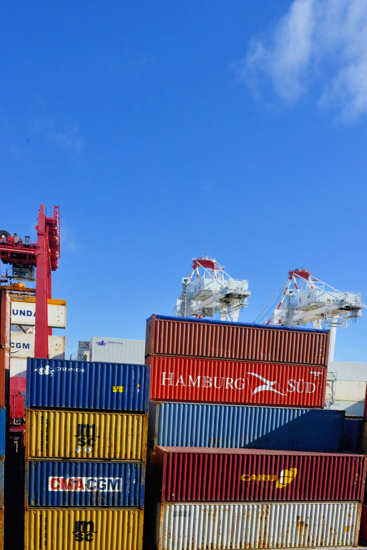 Colorful shipping containers stacked at a busy port, representing the PORT environment variable your app needs to actually listen on