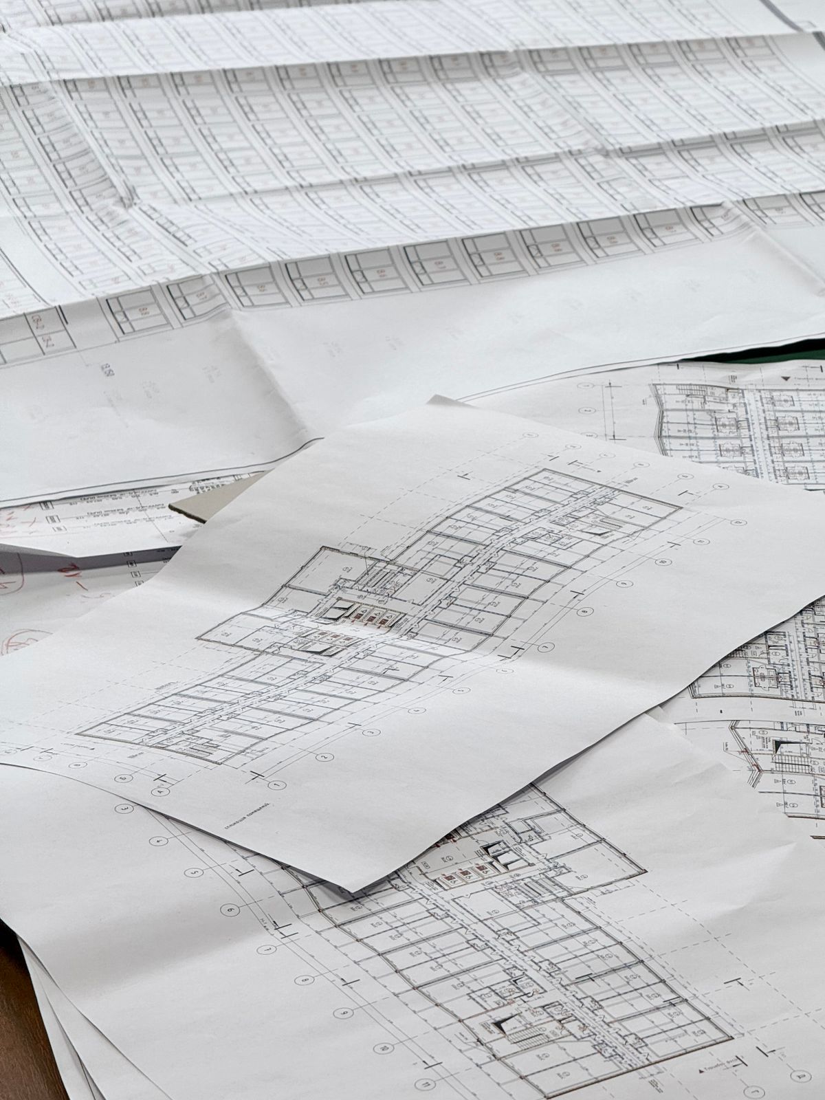 Detailed architectural blueprints spread across a desk, representing a separate shadow database created deliberately instead of improvised on the fly