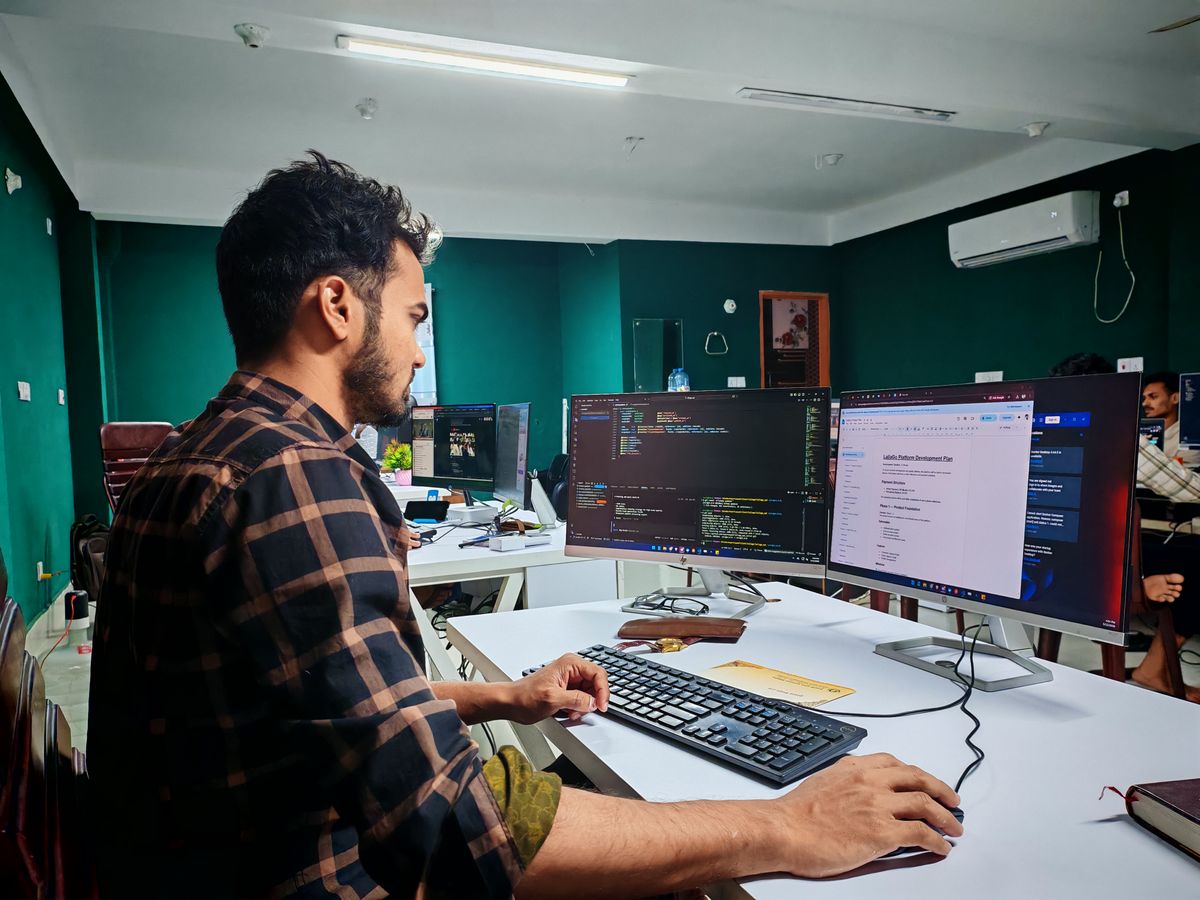 A software developer working on dual monitors, debugging a production deployment issue