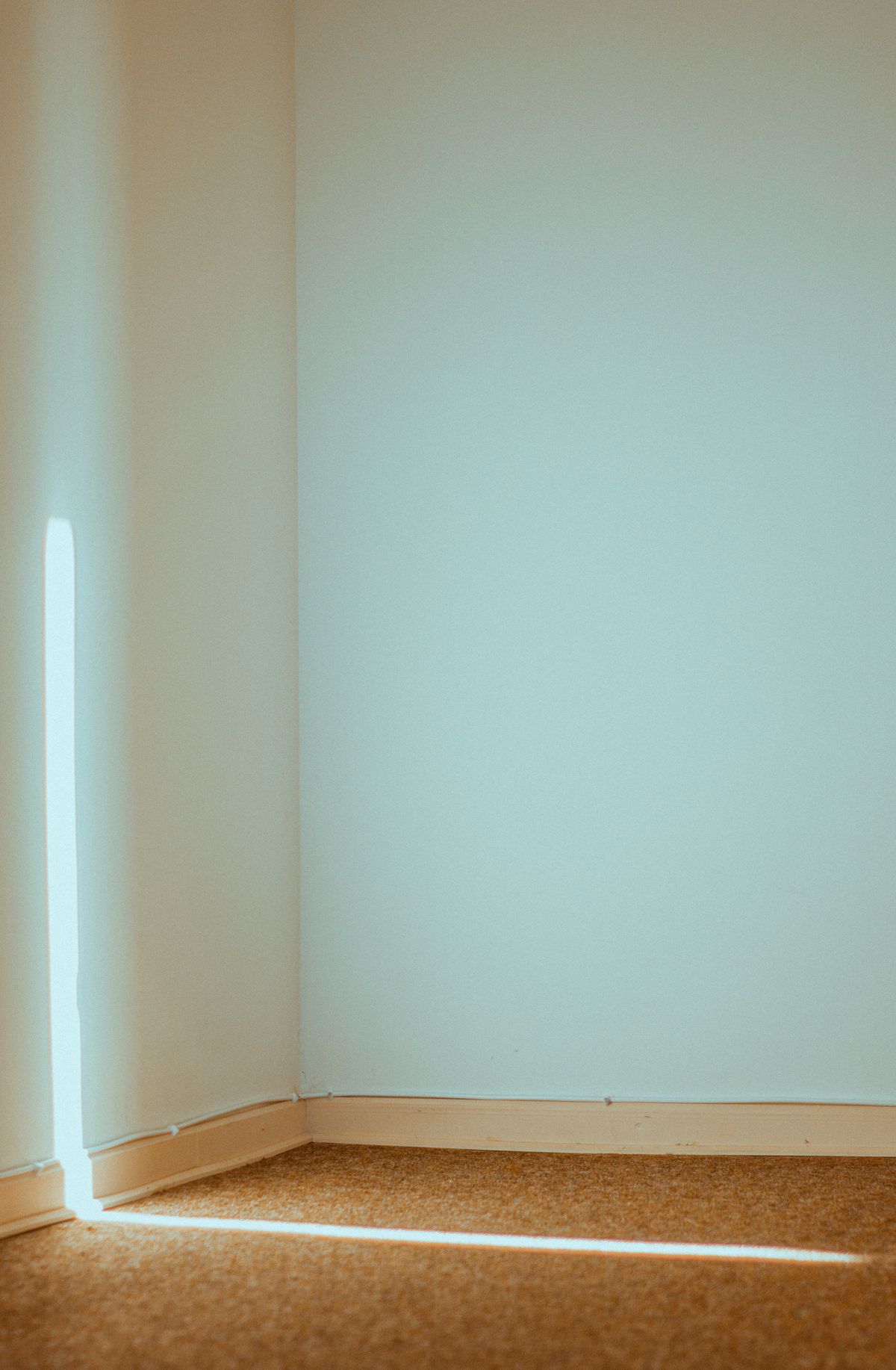 A quiet, empty room with sunlight streaming through a window, representing a Neon compute scaled down to zero during a period of inactivity