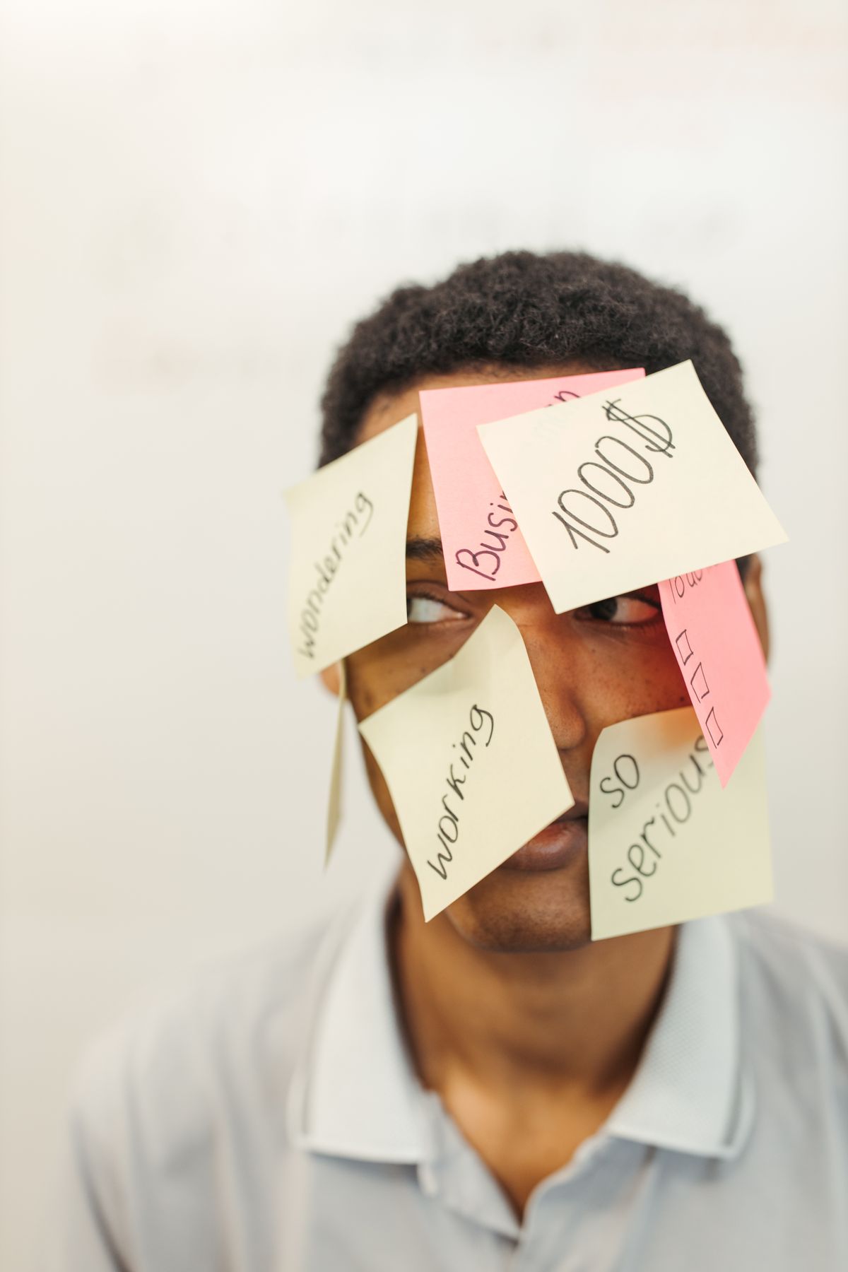 A businessman with sticky notes covering his face, representing a worker's event loop too overloaded with synchronous work to renew its own job lock in time